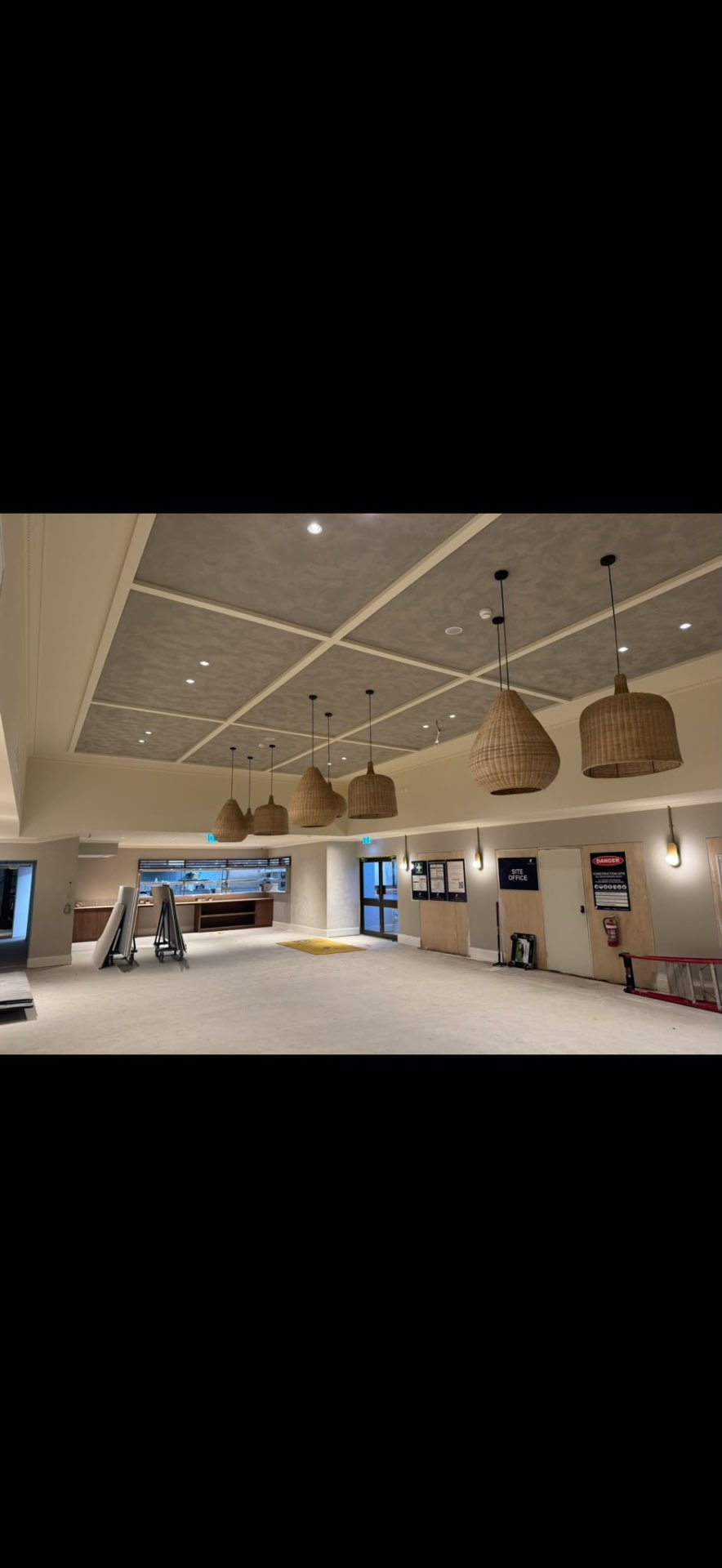 A coffered ceiling with pendant lights, finished in cream and taupe