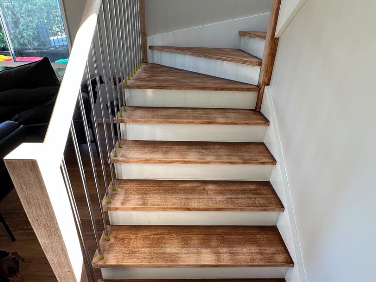 Timber staircase with worn natural finish before painting