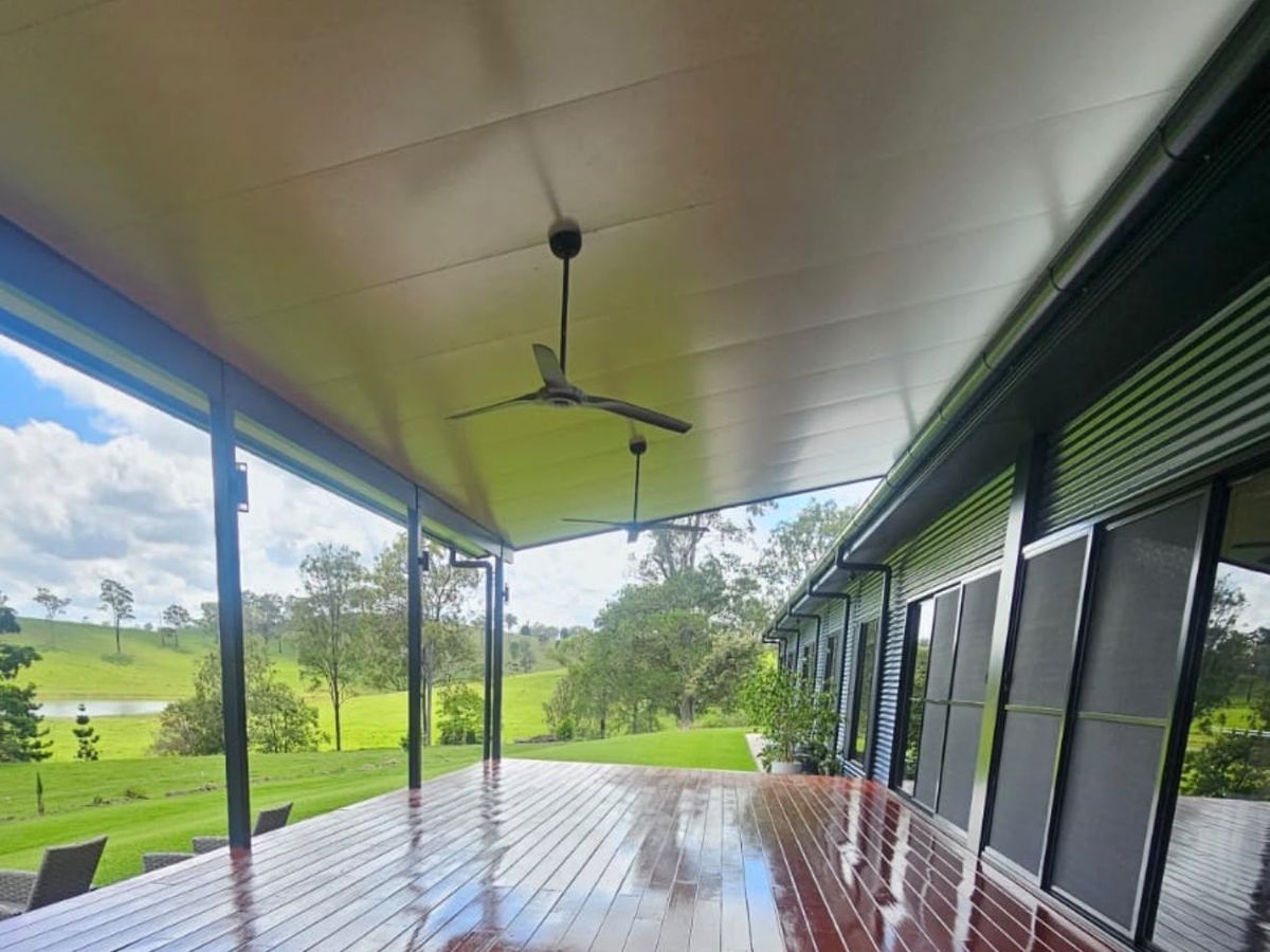 Restored timber deck with rich stained finish and rural outlook